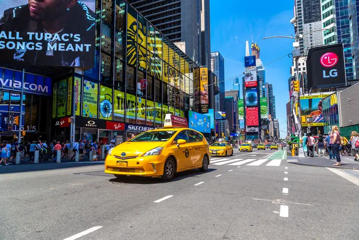 Four yellow cabs on Broadway in Times Square
